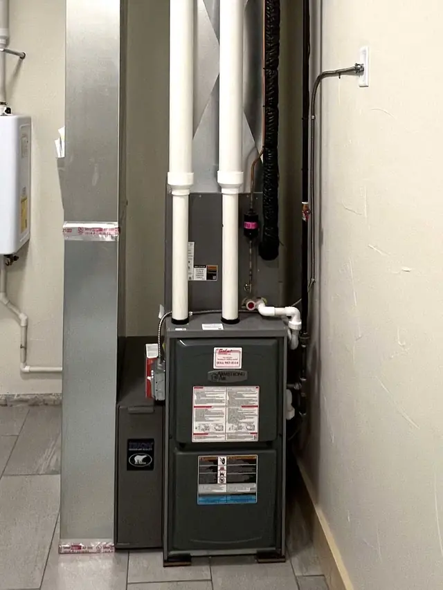 Armstrong Air furnace installed and finished, with the Comfort Heating service sticker on the cabinet