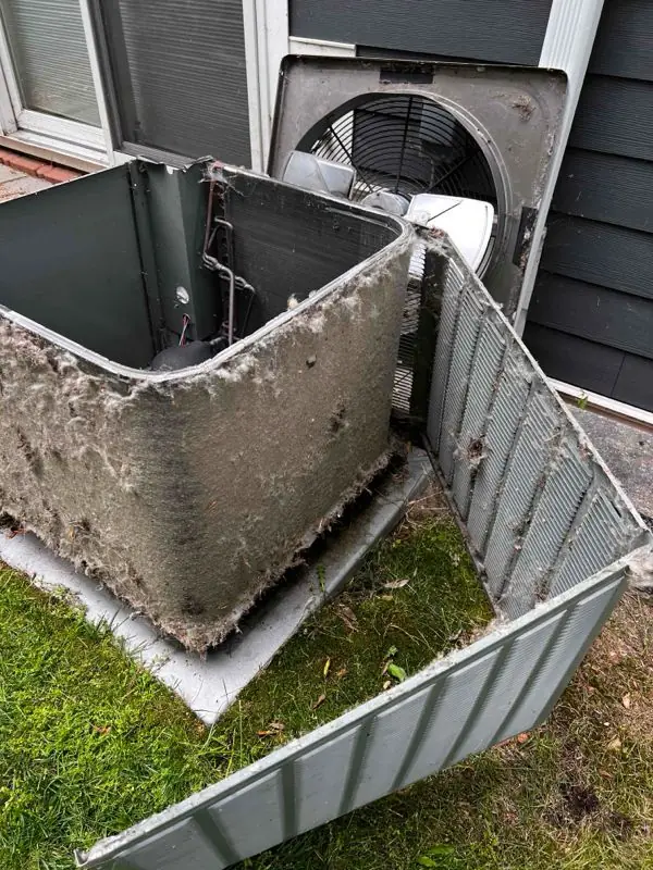 A heavily soiled AC condenser coil awaiting service