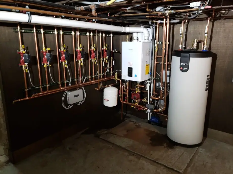 A finished tankless water heater, storage tank and radiant manifold installed by Comfort Heating