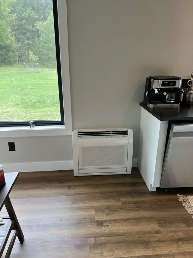 Fujitsu AIRSTAGE floor mount mini split in a finished interior room